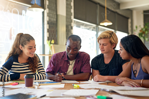 Student, writing and university notes at cafe with group, education and exam study for learning. College research, restaurant and smile of young people with school project and paperwork for test