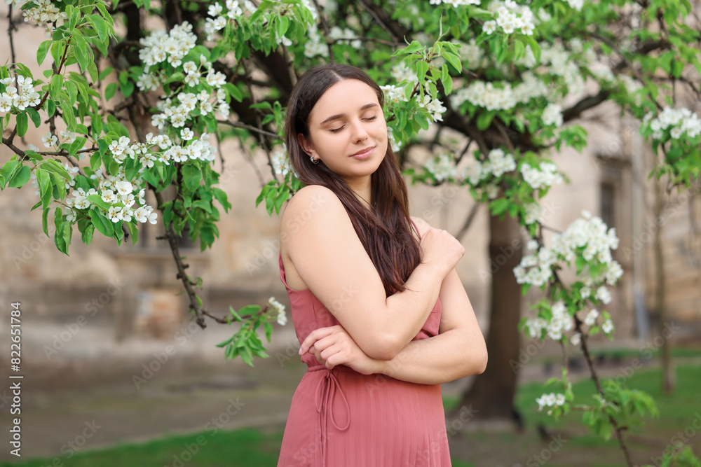 Beautiful woman near blossoming tree on spring day Beautiful woman near blossoming tree on spring day