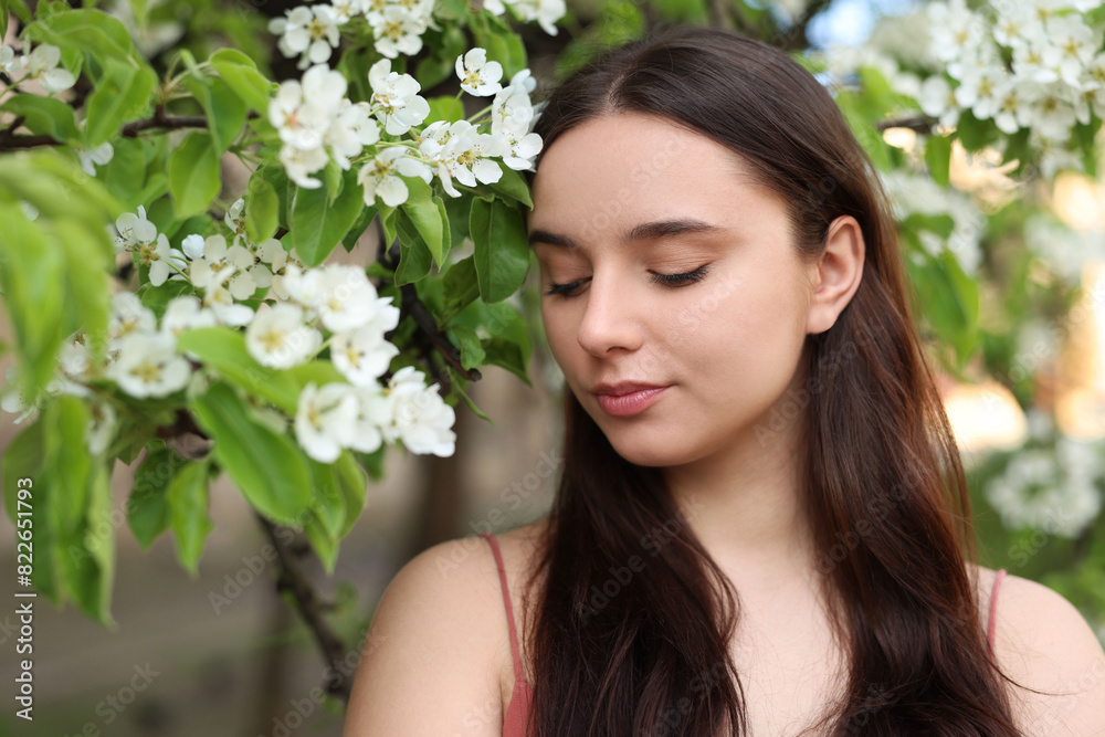 Beautiful woman near blossoming tree on spring day Beautiful woman near blossoming tree on spring day