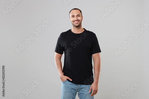 Man wearing black t-shirt on gray background