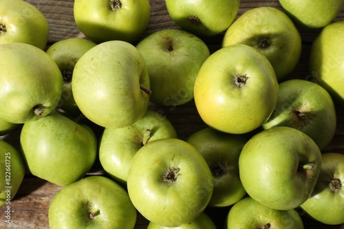 Many fresh apples on wooden table, top view