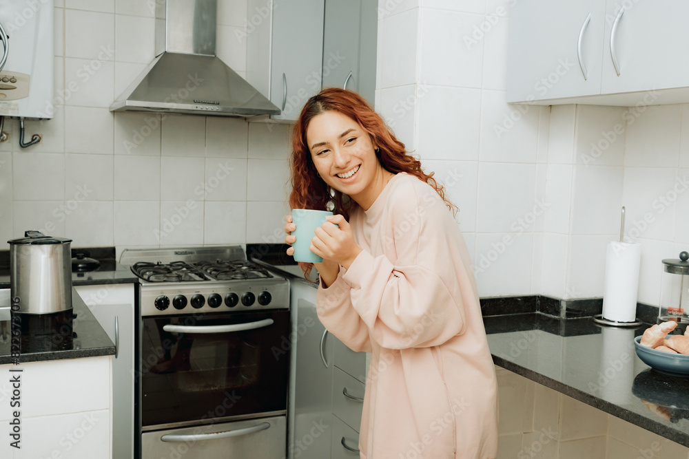 Young woman drink coffee in the kitchen Young woman drink coffee in the kitchen