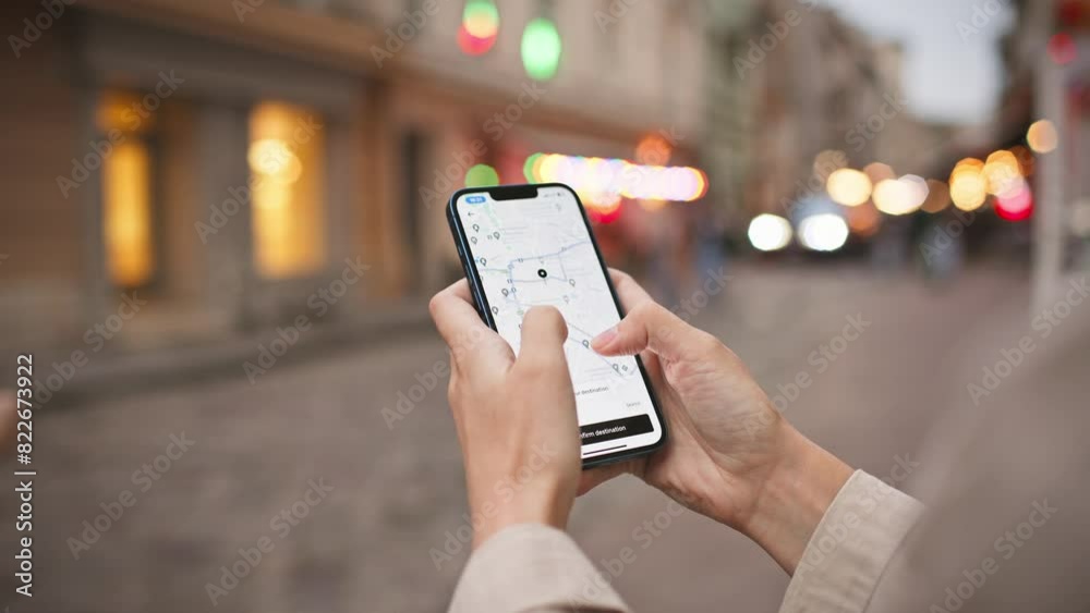 Woman standing in middle of street while using phone. Map visible on screen. Finding right path with digital gadget. Navigation search in app. Concept of location. GPS coordinates.