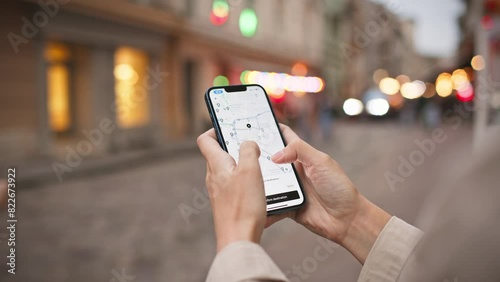 Woman standing in middle of street while using phone. Map visible on screen. Finding right path with digital gadget. Navigation search in app. Concept of location. GPS coordinates.