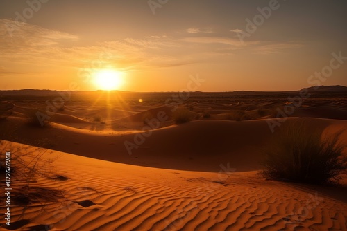 Tranquil and serene scene of a golden hour desert sunset over the vast rolling dunes, showcasing the untouched wilderness and peaceful environment of the arid landscape © juliars