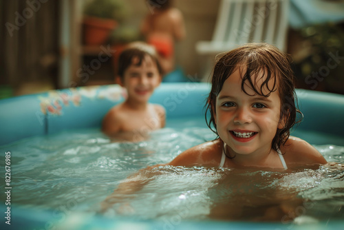 Two children smiling in inflatable pool with blurred background. Concept of childhood joy and playtime in summer