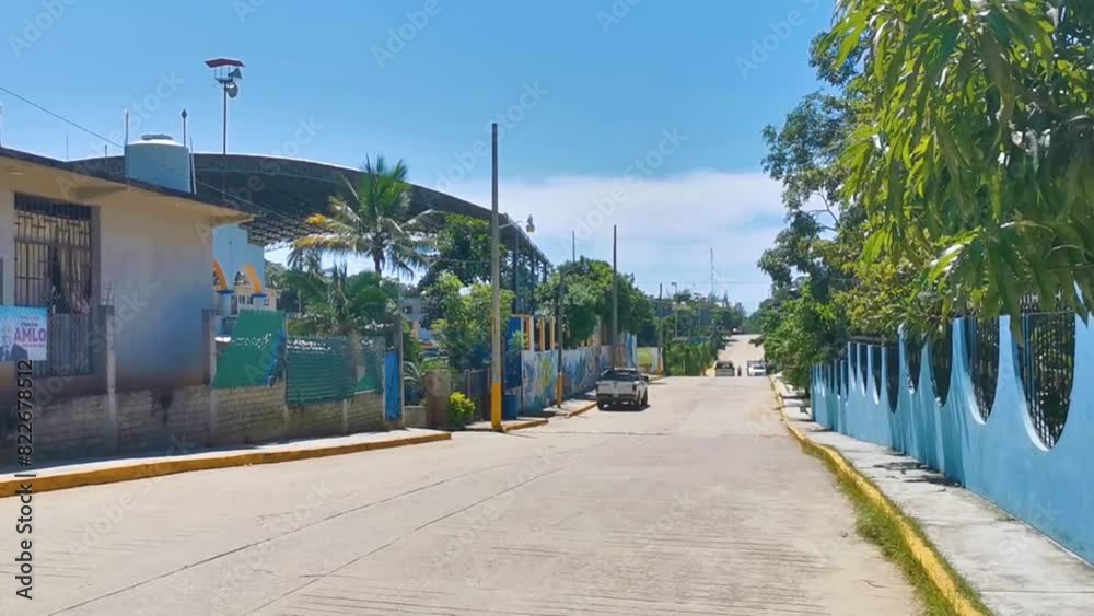 Colorful street with houses palms cars jungle Puerto Escondido Mexico. Colorful street with houses palms cars jungle Puerto Escondido Mexico.