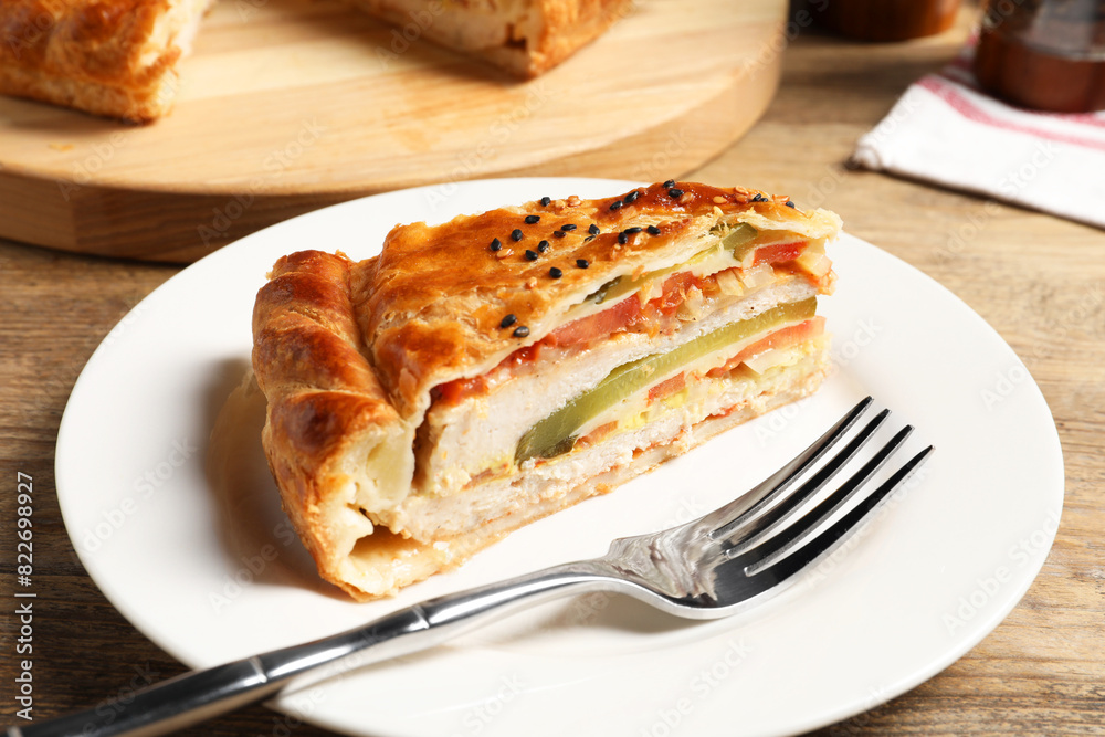 Piece of tasty homemade pie with filling served on wooden table Piece of tasty homemade pie with filling served on wooden table