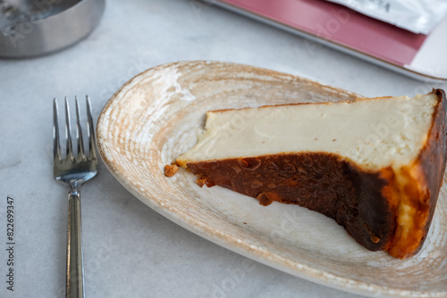 San Sebastian cheesecake on plate in restaurant in close-up photo