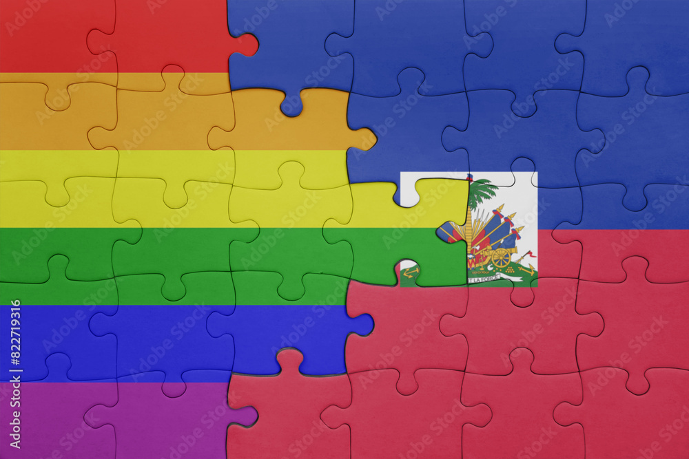 puzzle with the colourful national flag of haiti and rainbow gay pride flag . puzzle with the colourful national flag of haiti and rainbow gay pride flag .