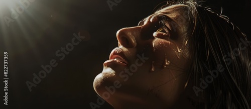 Biblical character. Emotional close up portrait of a woman with blue eyes in a veil looking up. Looking up to heaven with tears in her eyes, full-length shot set in biblical times,