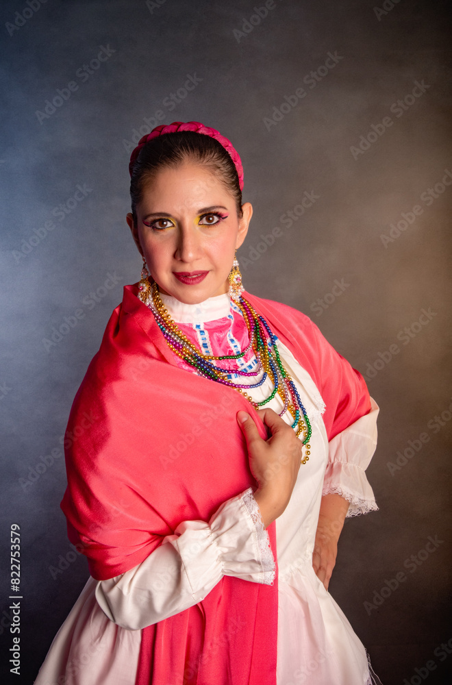 Fototapeta premium Mexican woman with Mexican warrior state costume A woman wearing a red dress and a pink headband