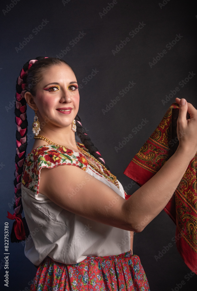 Fototapeta premium Mexican woman with Mexican warrior state costume A woman wearing a white shirt and red skirt holding a red cloth