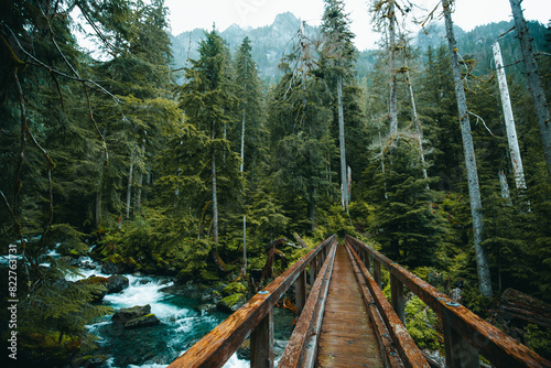 Authentic wooden bridge over the river on Trout Lake Trail in Washington State, USA photo