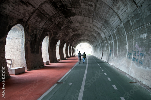 People walking through tunnel