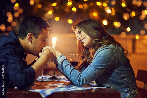 Фотография Date, hand kiss and excited woman in couple at restaurant for marriage and celebration with love