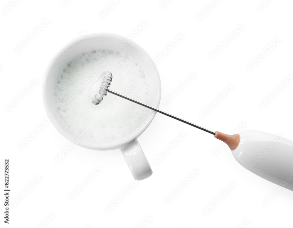 Whisking milk in cup with mini mixer (frother wand) isolated on white, top view Whisking milk in cup with mini mixer (frother wand) isolated on white, top view