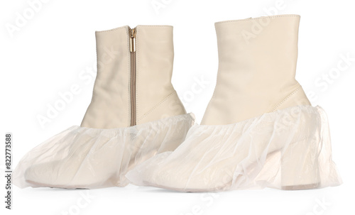 Women's boots in shoe covers isolated on white © New Africa