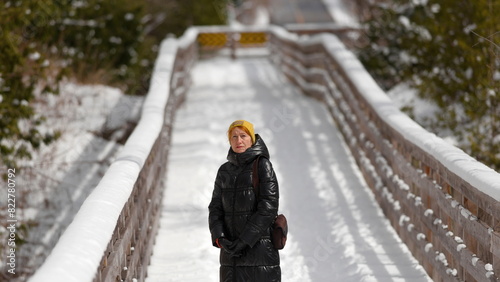 Photography Serenity in Snow: Womans Birdwatching Adventure on a Toronto Bridge