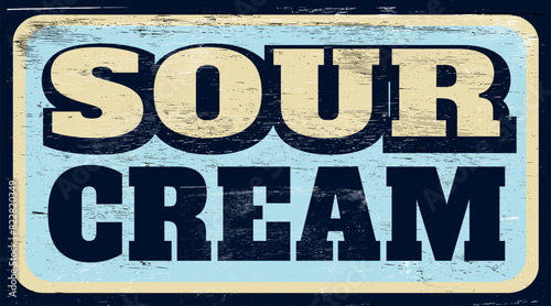 Aged and worn retro sour cream sign on wood
