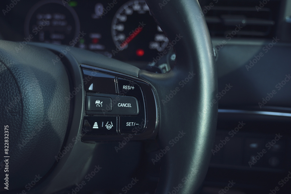 interior view of car with black leather, steering wheel with button