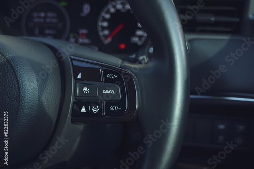 interior view of car with black leather, steering wheel with button © sutichak