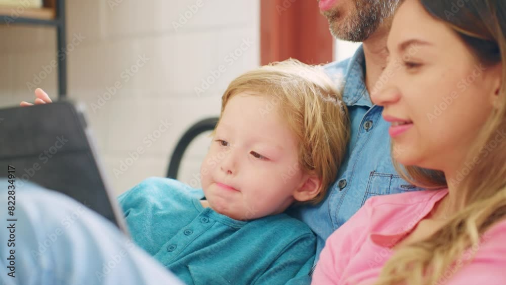 Caucasian attractive couple using tablet with young baby boy on bed. Caucasian attractive couple using tablet with young baby boy on bed.