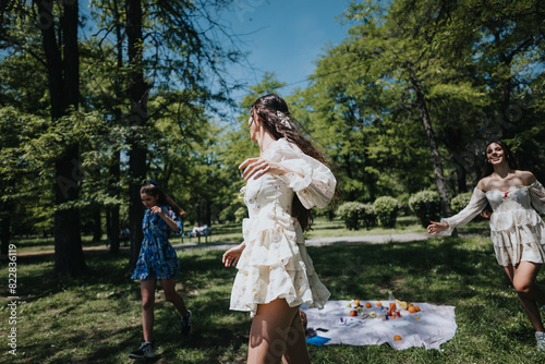 Bild auf Leinwand Three young women frolicking outdoors in a lush park, embodying freedom and joy on a bright sunny day