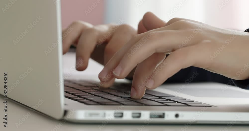 Childs hands actively typing on a laptop keyboard, focusing on finger movement and keys in a close-up shot. Childs hands actively typing on a laptop keyboard, focusing on finger movement and keys in a close-up shot.