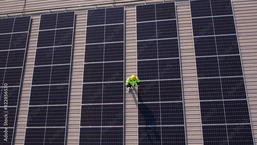 Drone view of engineer worker installed solar panels on roof of house. Drone view of engineer worker installed solar panels on roof of house.