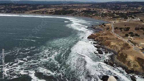 Aerial shot of a beach and the pacific ocean at Pichilemu, Chile