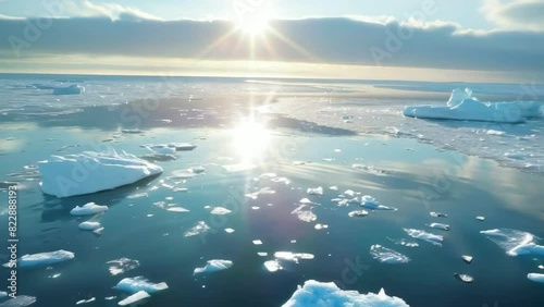 Sunlit Arctic ice floes drifting in the calm ocean at sunse Concept of climate change, serenity, and natural beaut photo