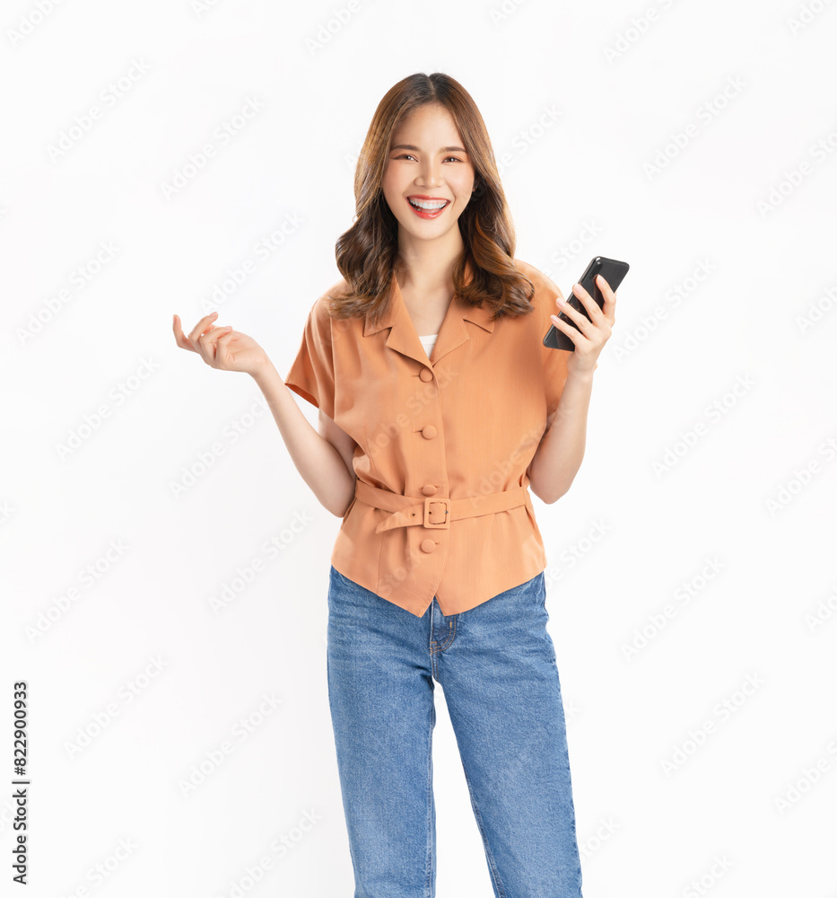 Studio shot of Beautiful Asian woman holding smartphone smiling on white background. Studio shot of Beautiful Asian woman holding smartphone smiling on white background.