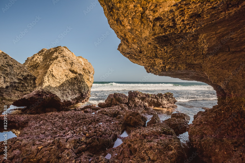 Fototapeta premium rocks on the beach ; beautiful nature with clear blue sky ; rocky indonesian beach