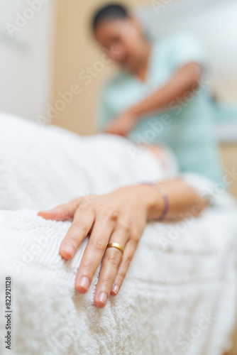 Relaxed hand of a woman lying while receiving a massage