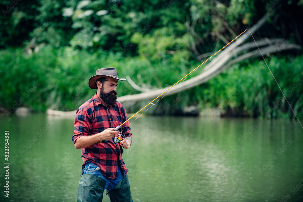 Fisherman using rod flyfishing in mountain river. A fly fisherman fishing for wild trout on the river in the forest. Fisherman using rod flyfishing in mountain river. A fly fisherman fishing for wild trout on the river in the forest.