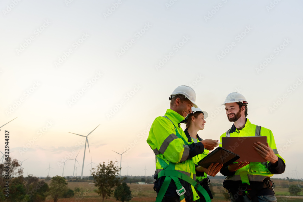 Engineer wearing safety uniform using tablet discussed plan about renewable energy at station energy power wind turbine. technology protect environment reduce global warming problems. Engineer wearing safety uniform using tablet discussed plan about renewable energy at station energy power wind turbine. technology protect environment reduce global warming problems.