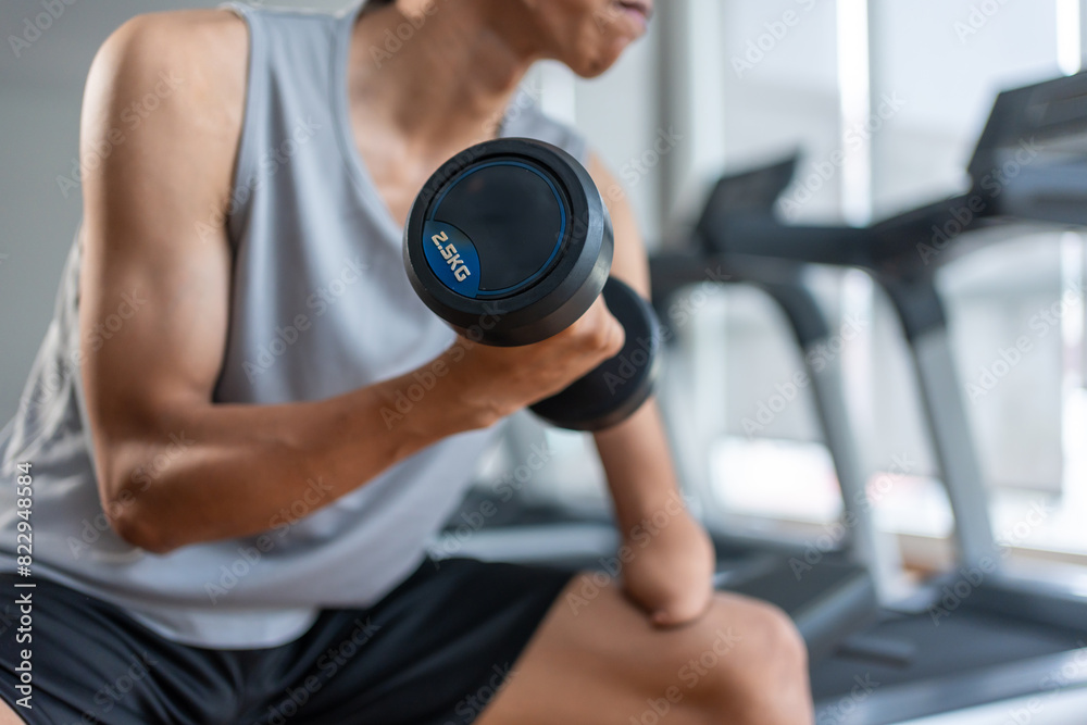 Asian young amputee without arm lift up weight dumbbell in fitness gym. Asian young amputee without arm lift up weight dumbbell in fitness gym.