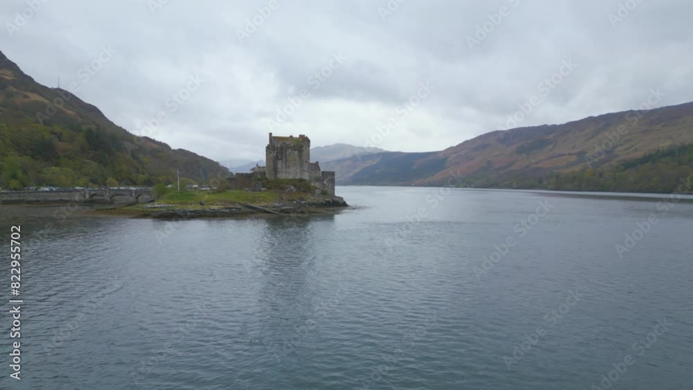 Eilean Donan Castle on a misty day, surrounded by water and mountains in Scotland Eilean Donan Castle on a misty day, surrounded by water and mountains in Scotland