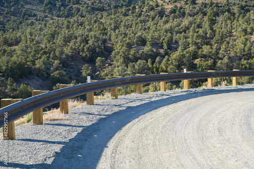 Curve overlooking steep drop with guard rail.  