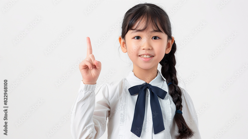 Young girl pointing up with a thoughtful expression, emphasizing an idea or solution, on a white background with copy space Young girl pointing up with a thoughtful expression, emphasizing an idea or solution, on a white background with copy space