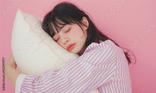 Naklejka 枕を持って寝ているパジャマ姿の女性