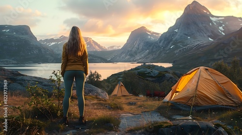 A woman stands on a mountain top next to a yellow tent generated by AI