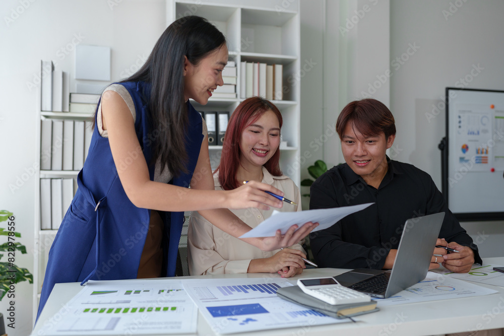 Team of happy professional businessmen and male office workers Working women using laptops, documents, notebooks discussing information about online marketing, finances, real estate in the company.