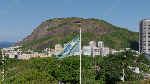 Slow motion aerial footage rotating around the flag of Brazil moving in the wind at the Yitzhak Rabin Park in Rio de Janeiro. photo