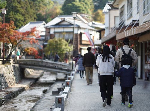 Tourists are walking around Kyoto in the atmosphere of the ancient city.