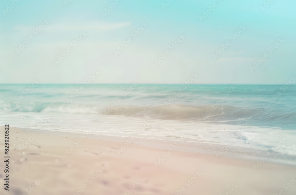 Blurred Background of a Sandy Beach with Waves and Blue Sea