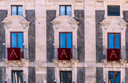 window with red banner or pennant with letter A for decotarion of old building facade