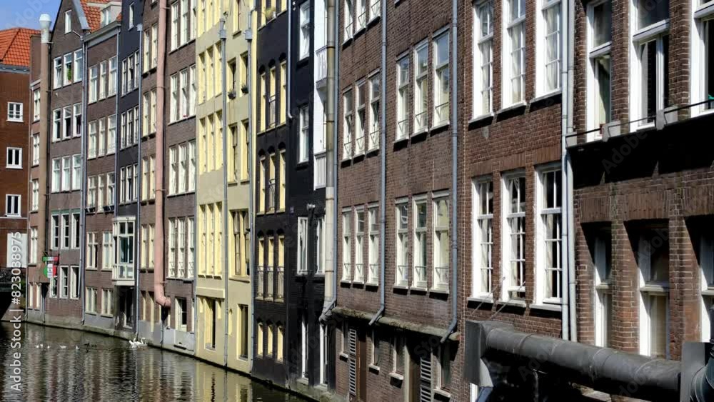 Canal and traditional waterfront buildings in Amsterdam, The Netherlands. Canal and traditional waterfront buildings in Amsterdam, The Netherlands.