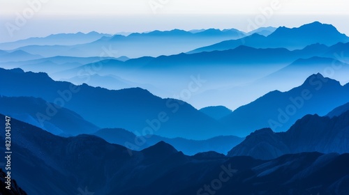 A panoramic view of multiple mountain peaks  each layered behind the other  creating a mesmerizing gradient of blue tones at dusk. 32k  full ultra hd  high resolution